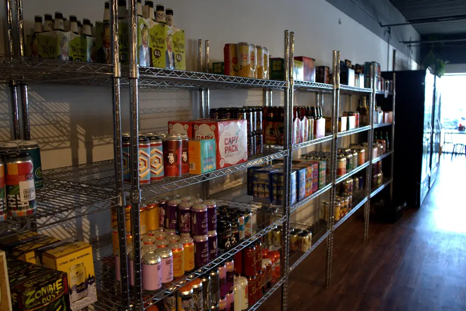 Craft beer cans and bottles on shelves